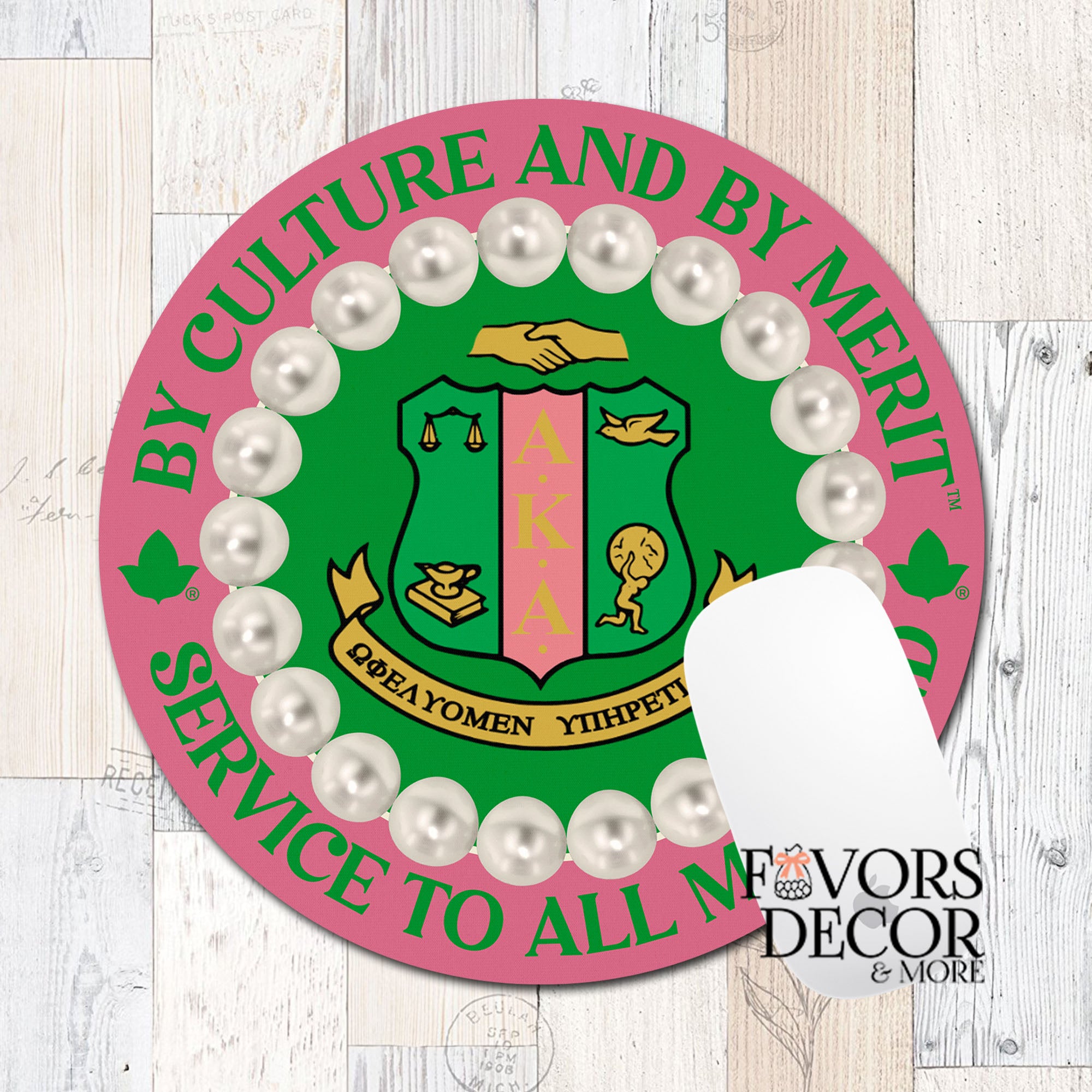 A round mouse pad featuring the Alpha Kappa Alpha sorority crest, surrounded by faux white pearls and bordered by green text reading 'BY CULTURE AND BY MERIT' and 'SERVICE TO ALL'. A white card is partially covering the lower right area.