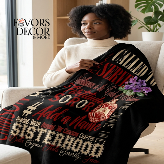 Woman sitting on a couch wrapped in a Delta Sigma Theta Blanket