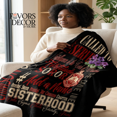 Woman sitting on a couch wrapped in a Delta Sigma Theta Blanket
